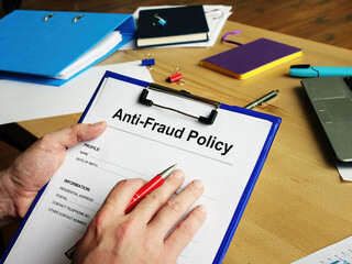 Man holds Anti Fraud policy empty form.