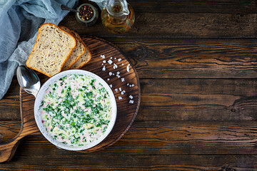 Russian traditional cold soup okroshka. Summer cold soup with yogurt and vegetables.
