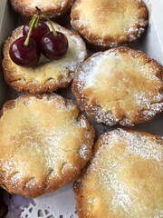 Delicious cupcakes with cherry jam on the table