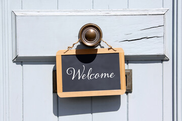 welcome sign hanging at door