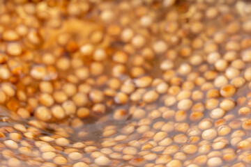 Cooking, boiling brown sugar flavor tapioca pearl balls, ingredient of bubble tea, preparing food and drink, close up, recipe cookbook steps design concept.