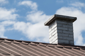 White brick chimney and tin roof.
