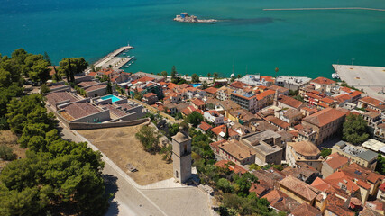 Aerial drone photo of medieval old clock tower in Acronafplia castle overlooking historic and picturesque seaside old town of Nafplio, Argolida, Peloponnese, Greece