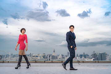 businessman and  working women walked past each other on the roof of the building and have a glimpse of their first impressions,And want to have a future together