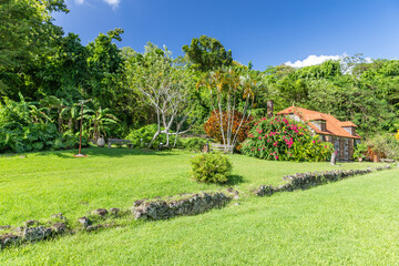 Green manicured lawn with ruins of sugar mill in the background it Trois Ilets, Martinique, France
