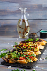 Bruschetta with chicken liver paste. Delicious bruschettas with various fillings. Different bruschetta ob wooden background