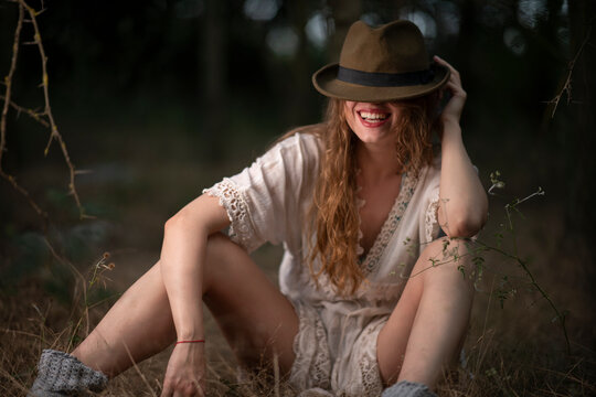 Beautiful young girl wearing a lace top posing in a dark forest