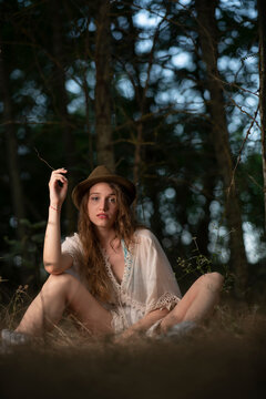 Beautiful young girl wearing a lace top posing in a dark forest