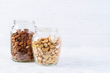 Cashew and almonds nuts in a jar. Set of nuts isolated on white background