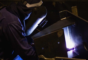 Metal workers use manual labor. Skilled welder. Factory workers making OT. Welder is welding the...