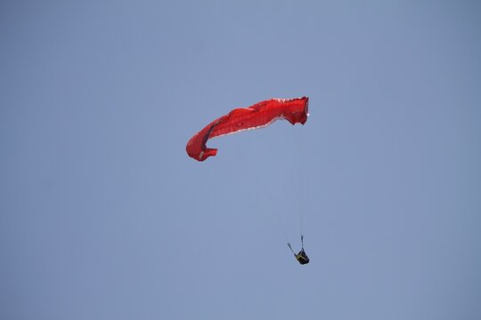 Closeup shot of a red paraplane on an empty sky