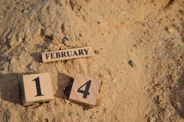 February 14, Number cube with Sand pile for a background.