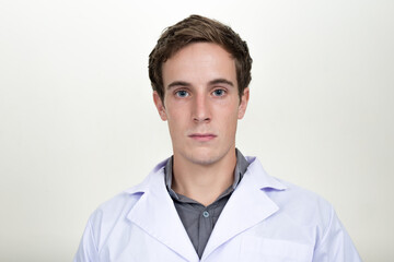 Face of young handsome man doctor looking at camera