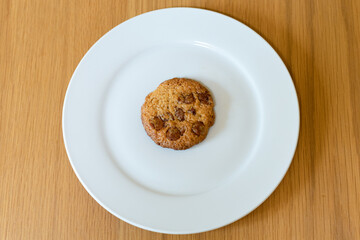 A delicious chocolate chip cookie on a plate.