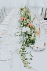 The wedding decor. Table set for an event party or wedding reception. Beautiful flowers on table.