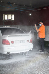 
A man washes a car with water