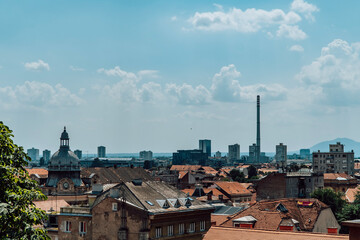 Panoramic view of Zagreb, Croatia from the Upper Town with ancient buildings, socialist residential blocks and an industrial chimney