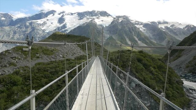 Beautiful Swing Bridge in Hooker Valley with Mount Sefton in New Zealand