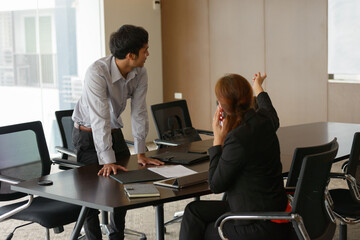 Multi ethnic business people having meeting with white board at the office