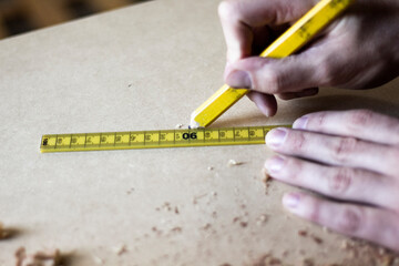 Carpenter hands working and measuring