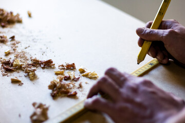 Carpenter hands working and measuring