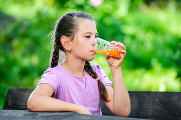Yang pretty European girl posing with glass of orange juice.