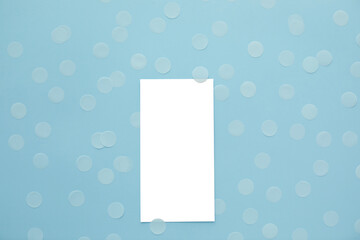Empty card and confetti on blue background. Mockup template. top view. Blank flyer
