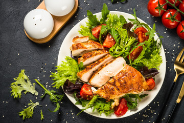 Grilled chicken with fresh salad at black.