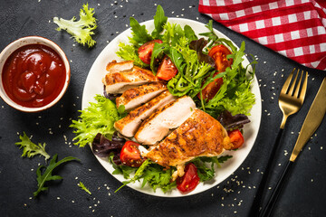Grilled chicken with fresh salad at black.