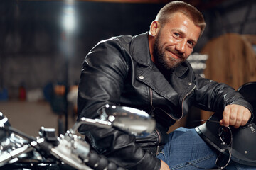 Obraz na płótnie Canvas Portrait of motorbike rider in black leather outfit