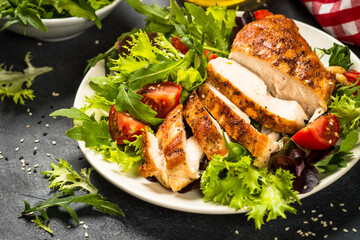 Grilled chicken with fresh salad at black.