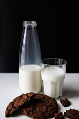 pouring milk in glass with chocolate cookies