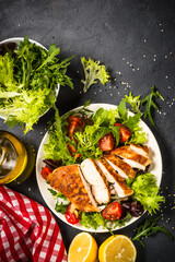 Grilled chicken with fresh salad at black.