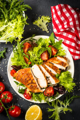 Grilled chicken with fresh salad at black.