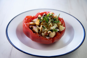 Stuffed premium tomato with beans, egg, and anchovies.