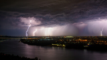 Naklejka na ściany i meble Rainstorm with lightnings over the big city.