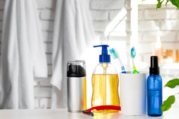 Cosmetic bottles against white bathroom wall background