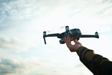 drone floating above hand ready to land,