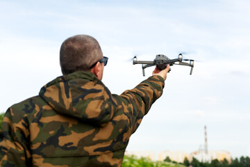 Fototapeta premium drone floating above hand ready to land,