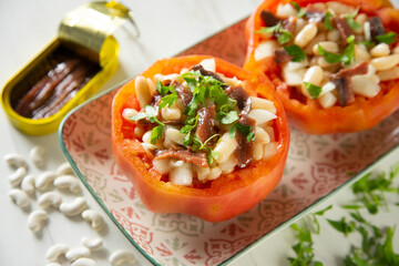 Stuffed premium tomato with beans, egg, and anchovies.