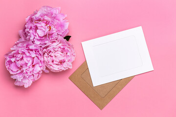 Flat Lay of two blank paper cards with a pink peonies on a pink background.