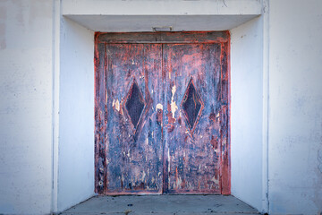 Old and rusty door, entrance to an old abandoned building
