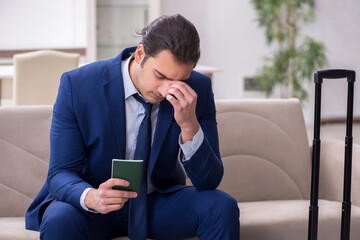 Young businessman holding passport preparing for trip