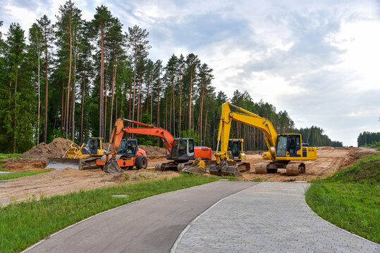 Bulldozer, Excavator and Soil compactor on road work. Earth-moving heavy equipment and Construction machinery  during land clearing, grading, pool excavation, utility trenching and digging