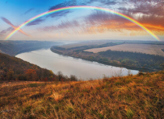Fototapeta na wymiar colorful rainbow over river canyon
