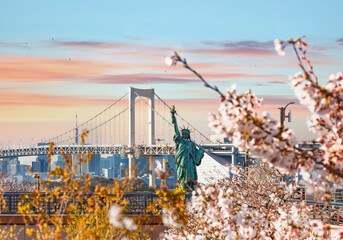 Replica of the french with cherry blossoms in the Odaiba Seaside Park in front of the double-layered suspension Rainbow Bridge in Tokyo bay. © kuremo
