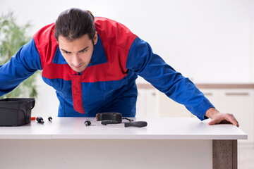 Young male carpenter working indoors
