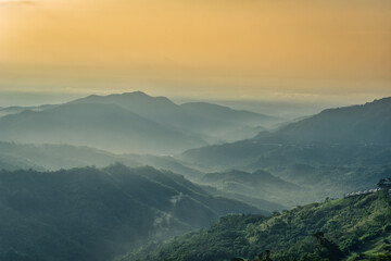 Foggy in the mountains with dramatic sky at sunrise