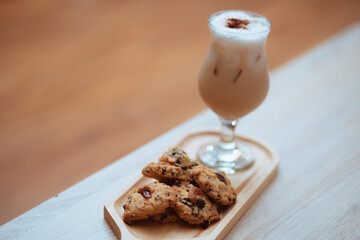 Cup of ice coffee and chocolate cookies for breakfast on wooden table