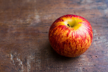 A beautiful apple on an old wooden table.